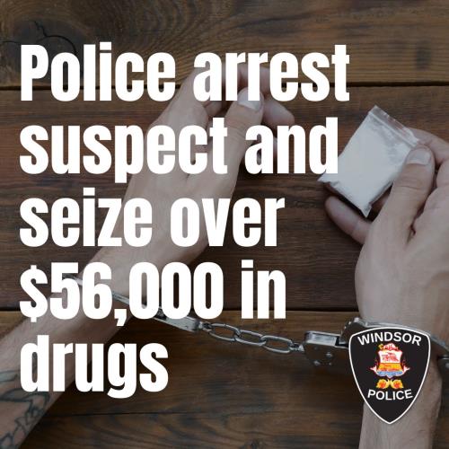 Stock photo of handcuffed hands holding small bag ofdrugs.